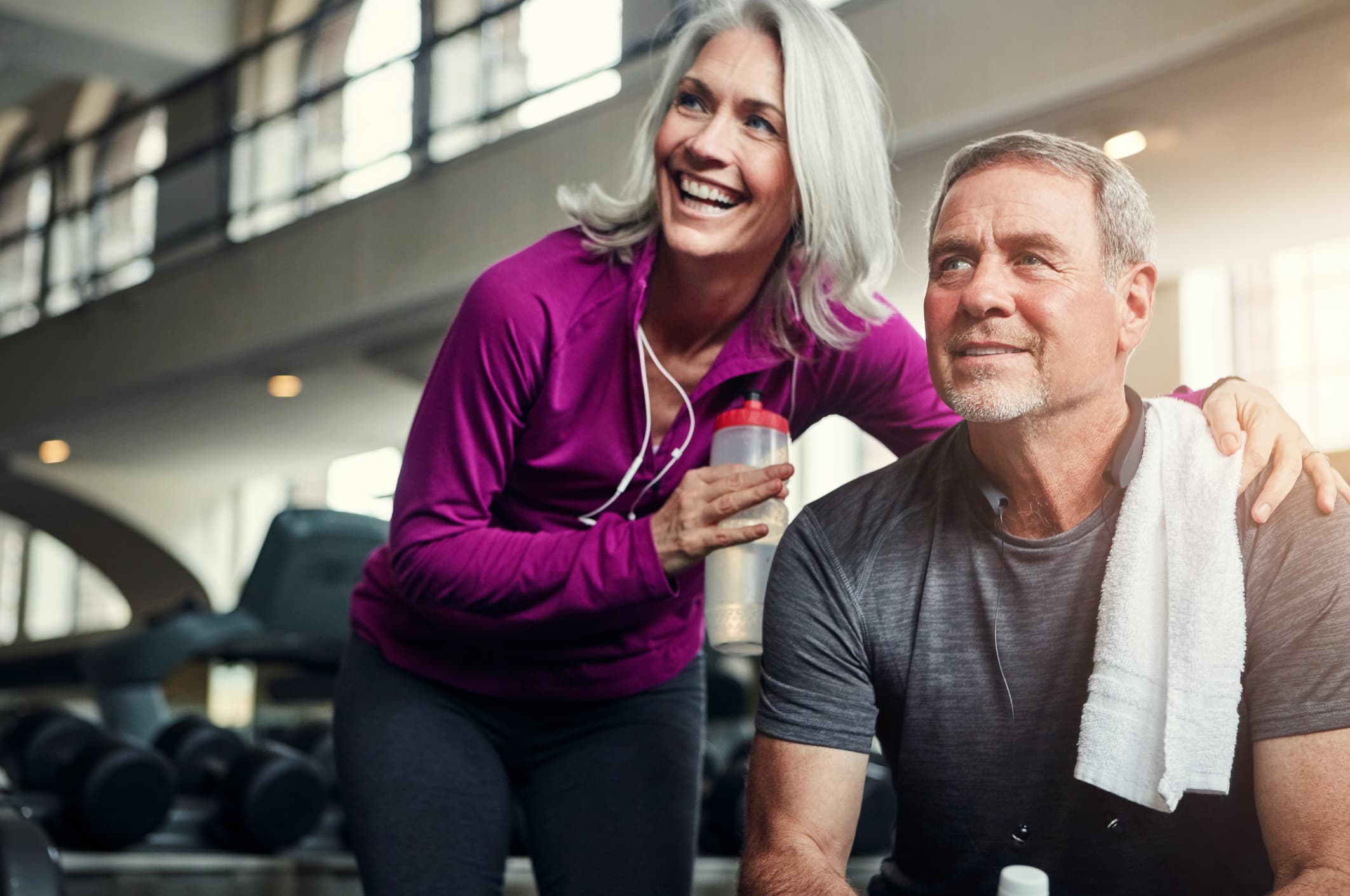 Man and woman exercising in gym representing active healthcare services