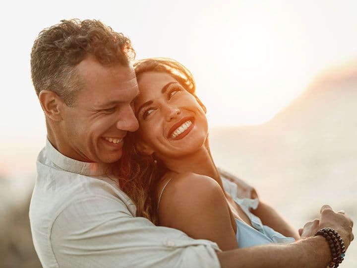 Husband and wife smiling